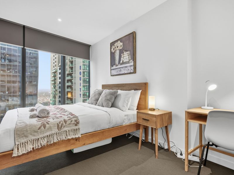 Wake up to natural light in a stylish bedroom designed for comfort.
