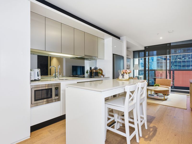 Prepare meals with ease in the sleek kitchen featuring a spacious island bench.