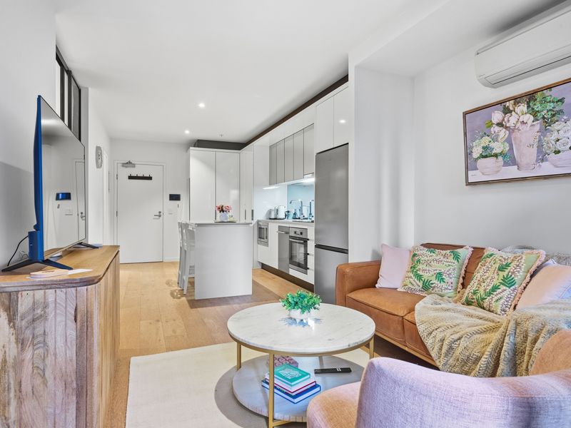 The open-plan living space seamlessly connects the lounge, kitchen, and dining areas.