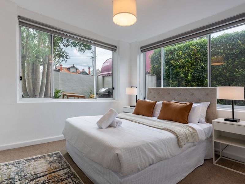 Comfortable bedroom with soft linens and garden views.