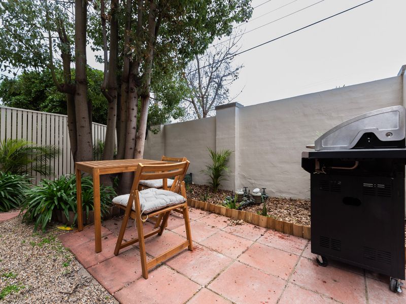 Private courtyard with BBQ and a peaceful outdoor dining space.