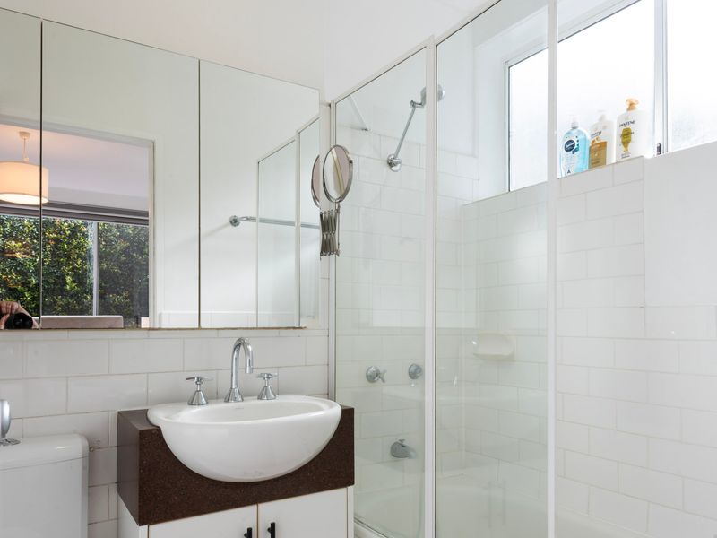 Modern bathroom with walk-in shower and vanity.