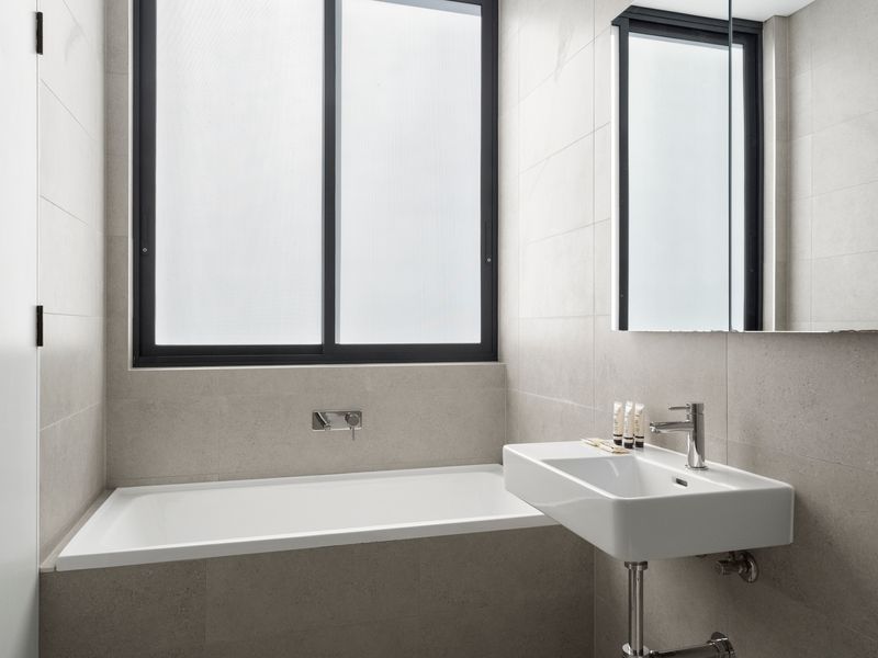 Refresh in the luxurious bathtub while natural light fills the space.