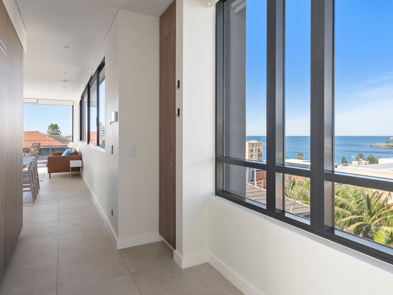 A wide hallway enhances the home's spacious and open feel.