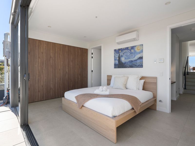 Another beautifully appointed bedroom offers a calm and restful escape.