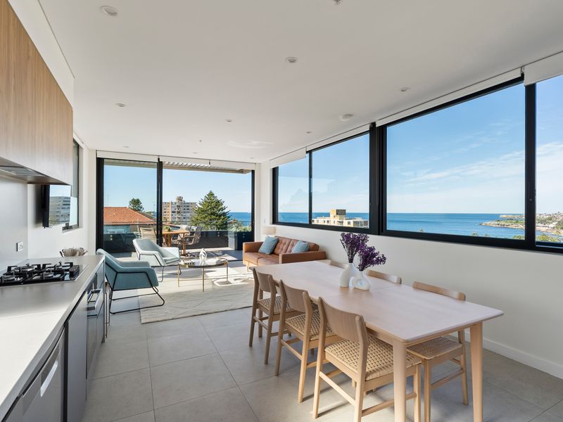 The open-plan dining area lets you enjoy every meal with a spectacular coastal backdrop.