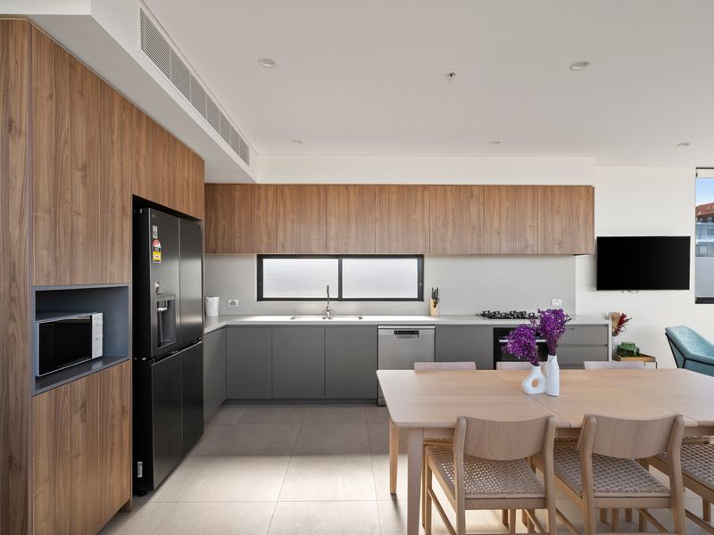 The designer kitchen combines premium appliances with elegant finishes.