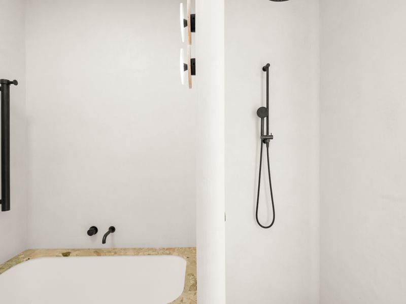 Spacious bathroom with sleek finishes and ample natural light.