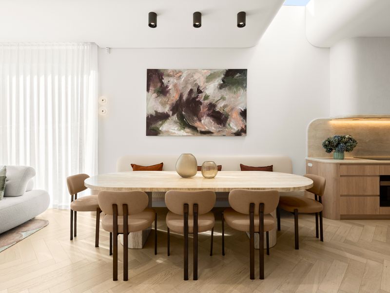 Elegant open-plan dining flowing into the designer kitchen.
