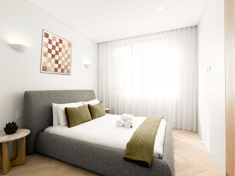 Comfortable queen bedroom with bedside table and calming décor.