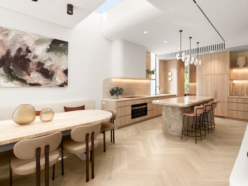 Designer kitchen featuring premium stone benchtops and warm timber cabinetry.