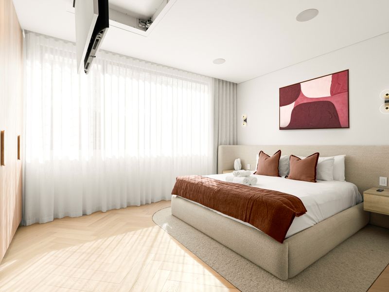 Relax in a calming retreat with plush bedding and oversized windows.