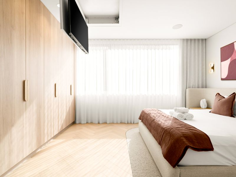 Spacious bedroom with full-height built-in wardrobes for effortless storage.