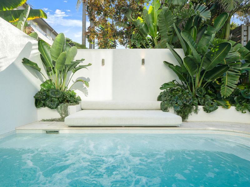 Refreshing pool surrounded by resort-inspired gardens.