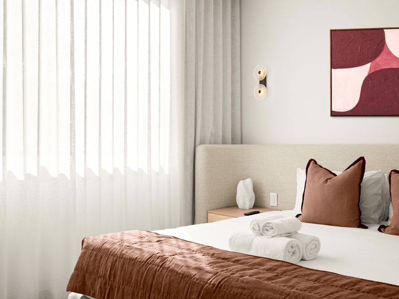 Wake up to soft natural light in this tranquil primary bedroom.
