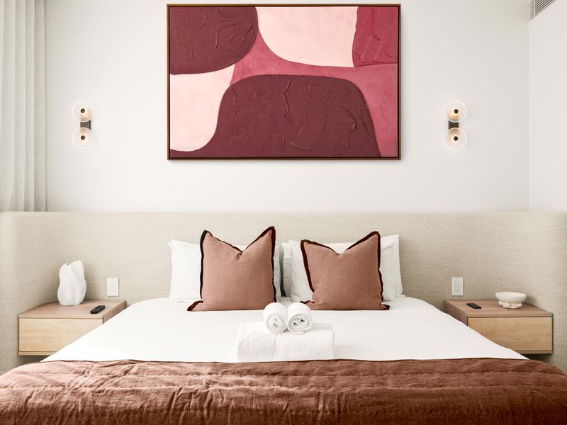 Serene bedroom styled with plush bedding and soft neutral tones.