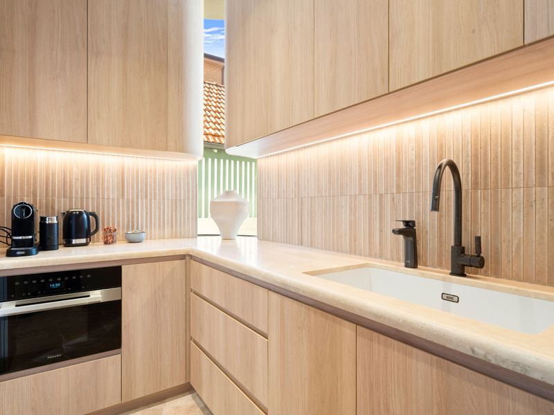 Sleek cooking space with modern appliances and ambient lighting.