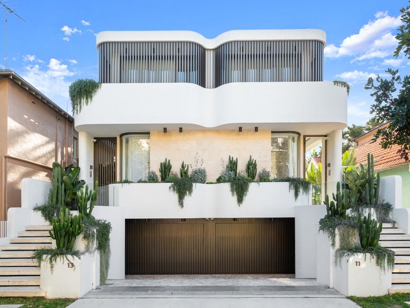 Striking contemporary façade with lush tropical landscaping.