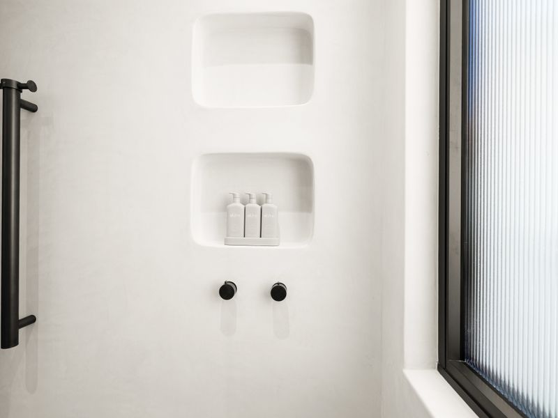 Shower niche with premium toiletries for your convenience.