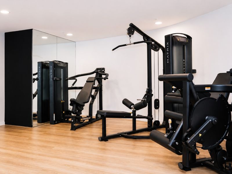 Modern fitness facilities with a range of strength equipment.