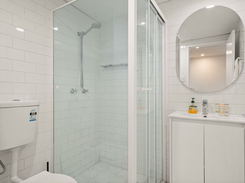 Fresh bathroom with walk-in shower and vanity.