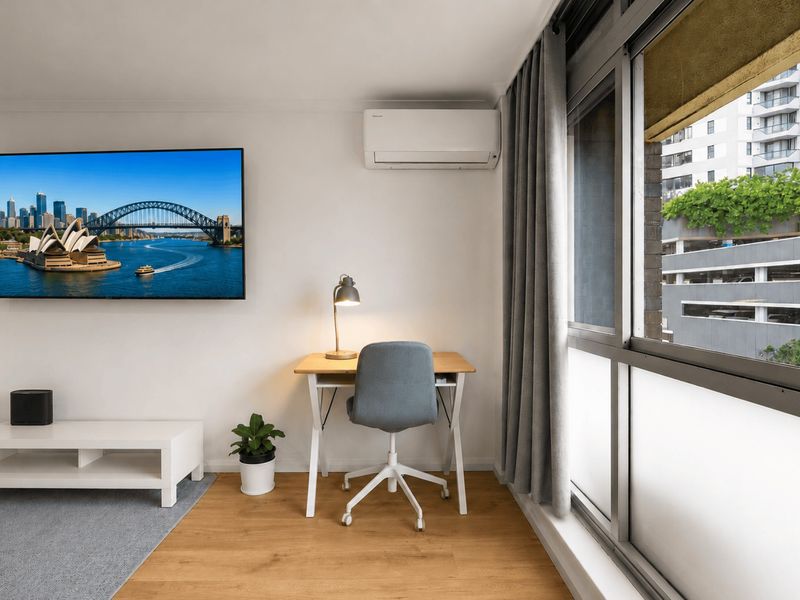 Bright living area with Smart TV and comfortable seating.