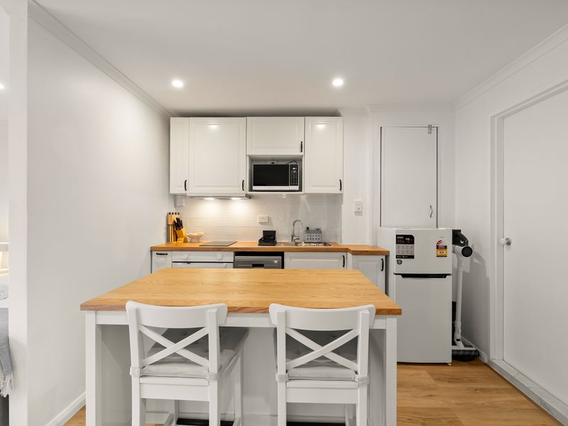 Modern kitchen with island seating and full-size appliances.