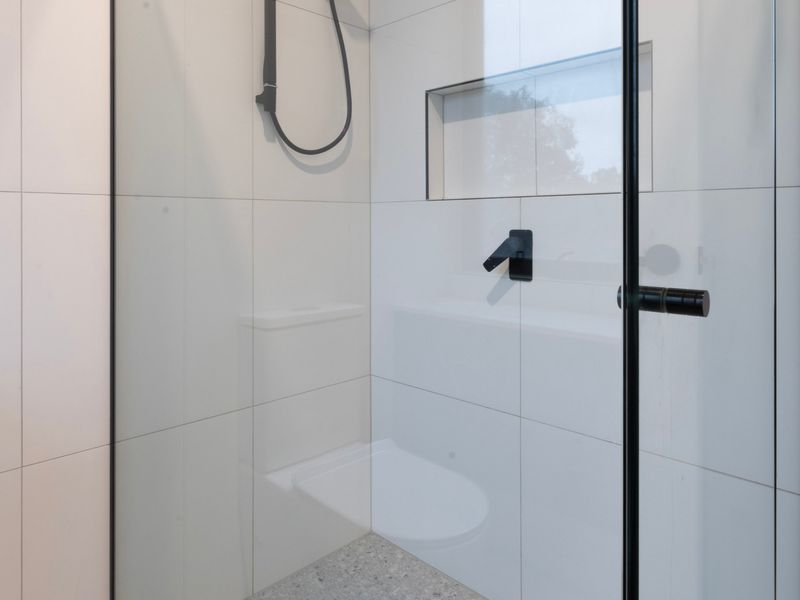 Contemporary walk-in shower with premium finishes.