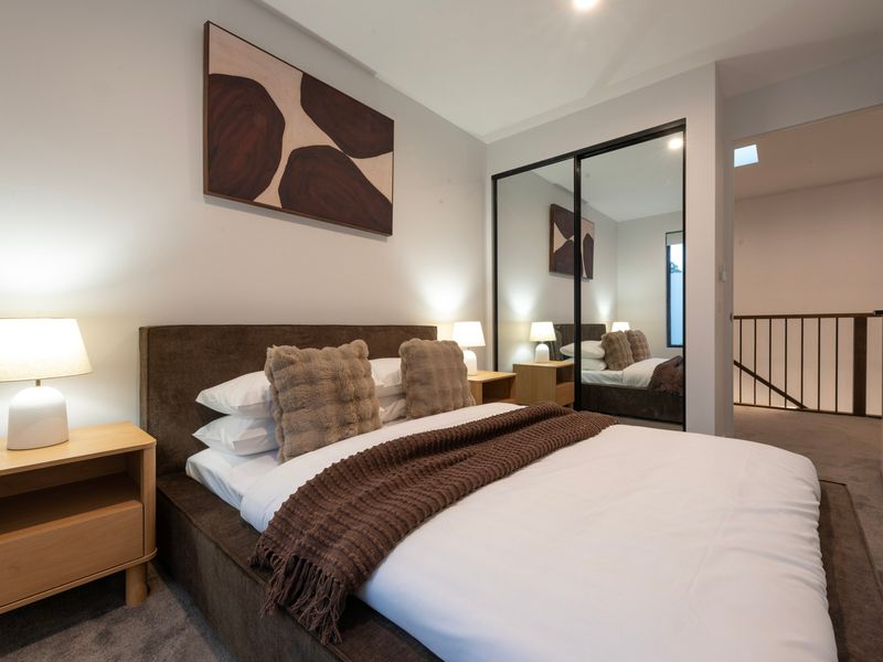 Beautiful bedroom with a queen bed and warm brown tones
