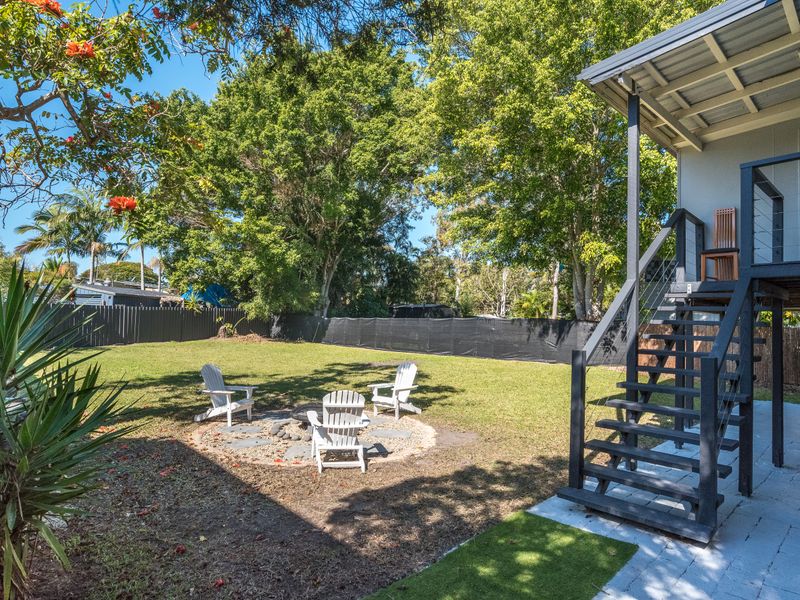 Outdoor entertaining area surrounded by established gardens.