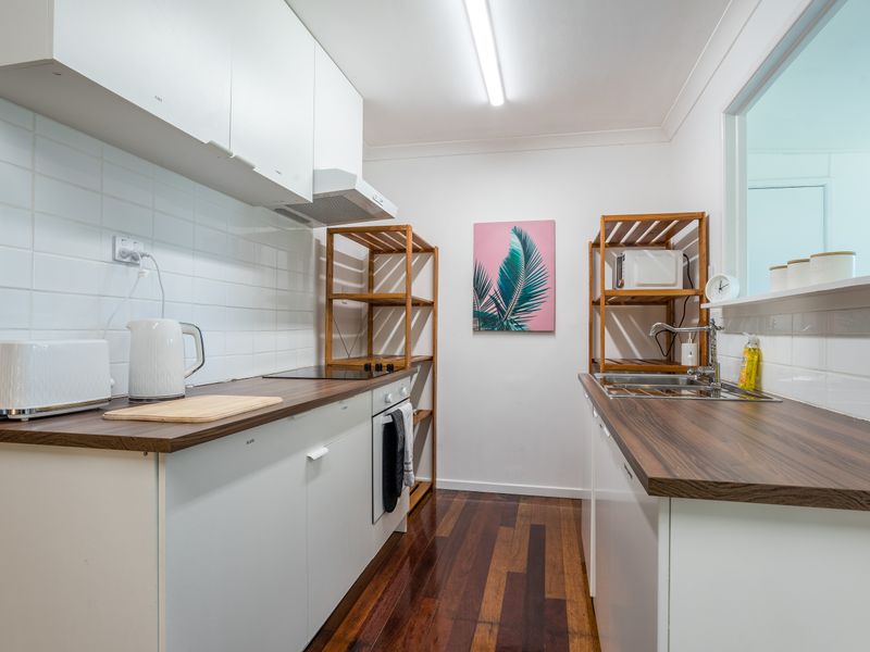 Well-equipped kitchen with generous bench space and essential appliances.