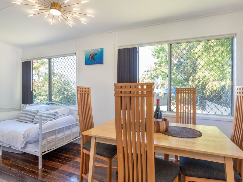 Cozy bedroom with tables and calming coastal décor.