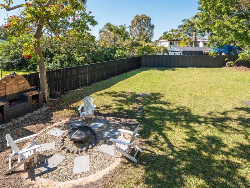 Spacious backyard with a dedicated fire pit for year-round enjoyment.