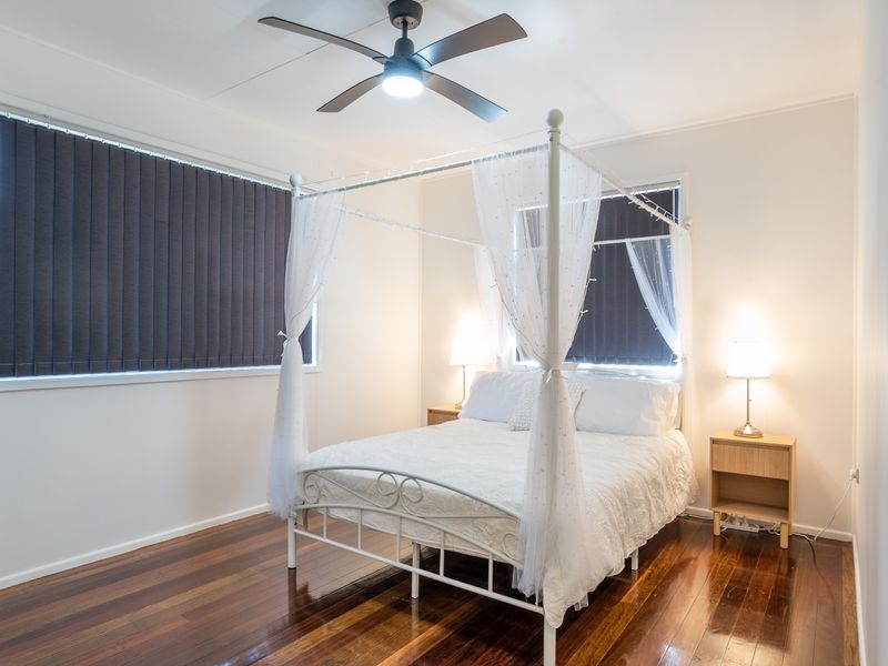 Peaceful bedroom with a charming four-poster bed and bedside lighting.