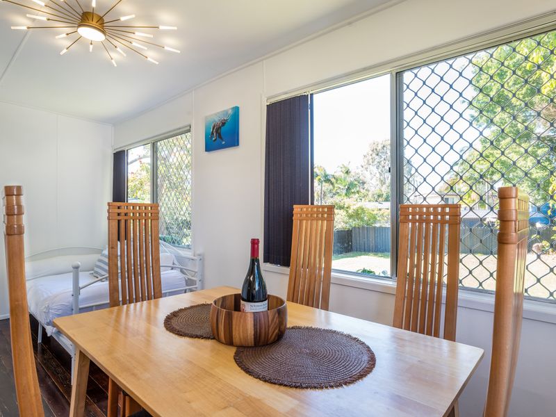 Open-plan dining and living area filled with natural light.