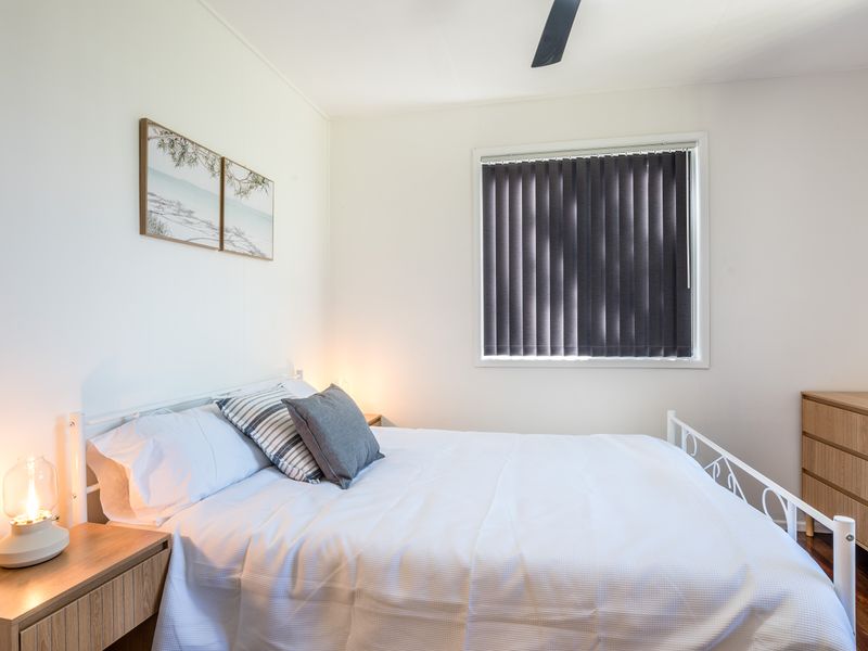 Comfortable bedroom with warm lighting and practical storage.