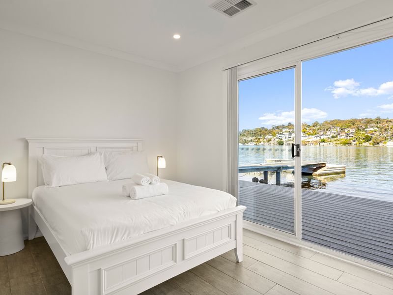 A serene bedroom with the bay just beyond