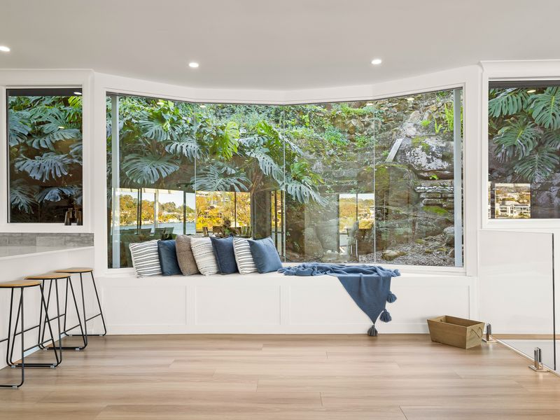 A peaceful window seat framed by greenery