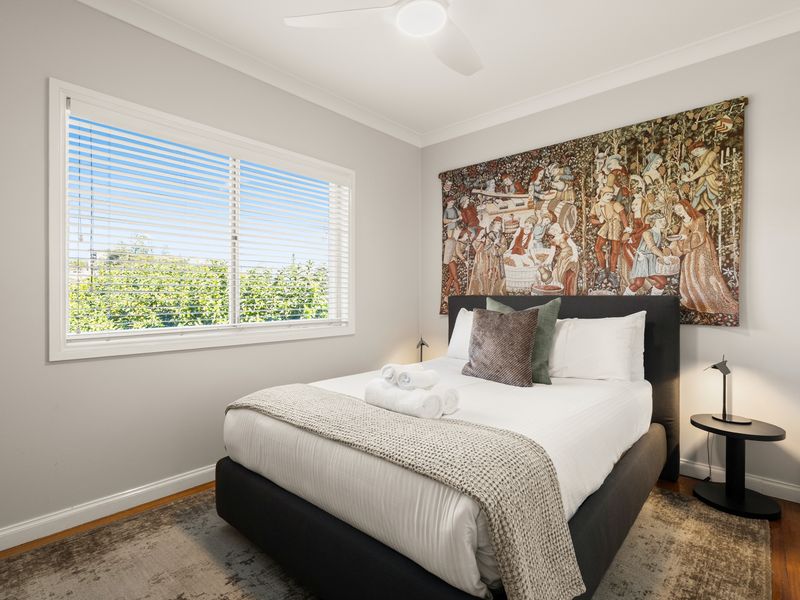 Comfortable bedroom with plush bedding and abundant natural light.