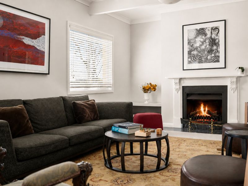Inviting living room featuring comfortable seating and a fireplace.