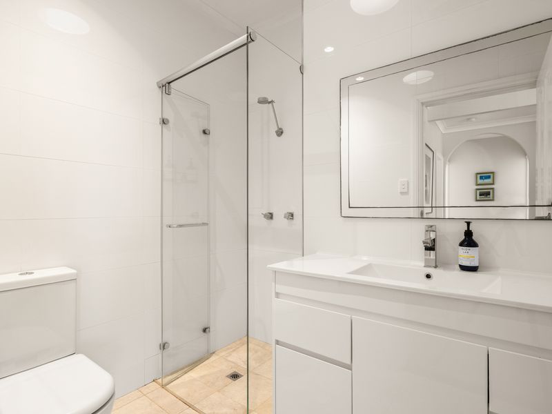 Modern bathroom with walk-in shower and quality finishes.