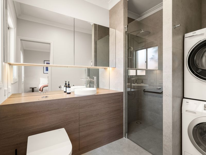 Contemporary bathroom with walk-in shower and modern vanity.