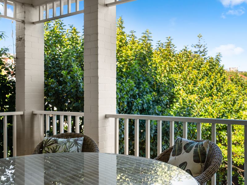 Private balcony surrounded by leafy greenery.
