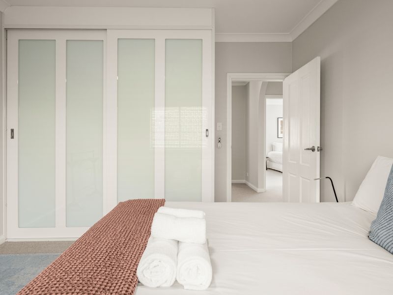 Spacious bedroom with built-in wardrobes and direct ensuite access.