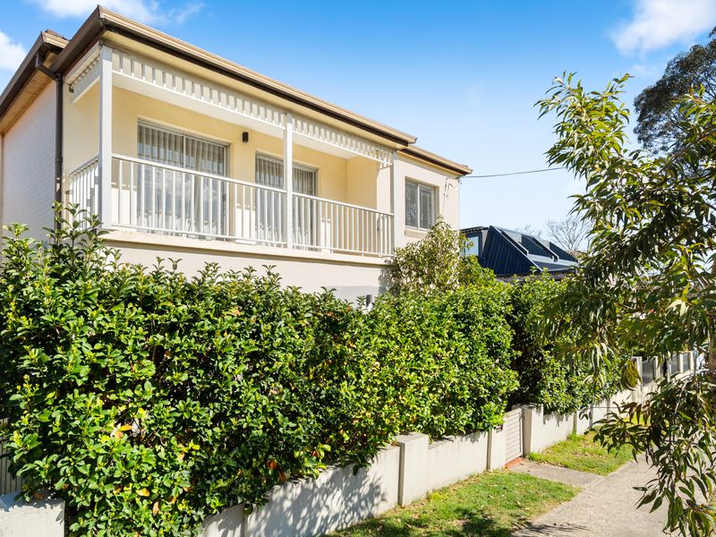 Exterior view of the home set in a quiet, leafy neighbourhood.