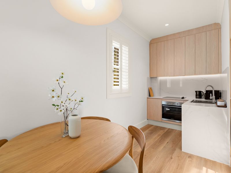 Dining area conveniently positioned beside the fully equipped kitchen.