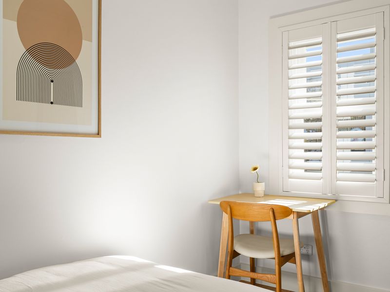 Sunny corner with a compact workspace beside the bedroom.