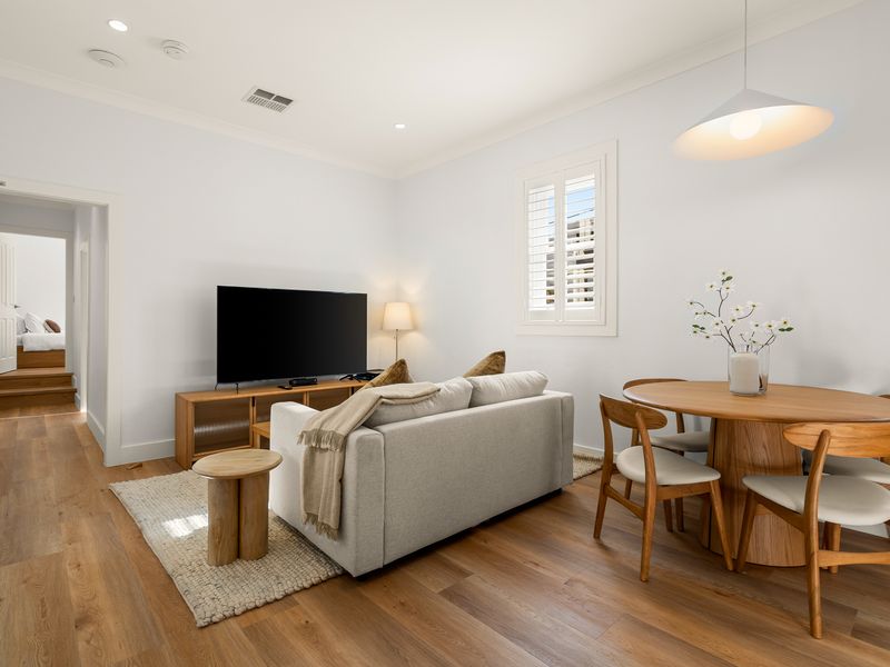 Another view of the bright living area flowing into the dining space.