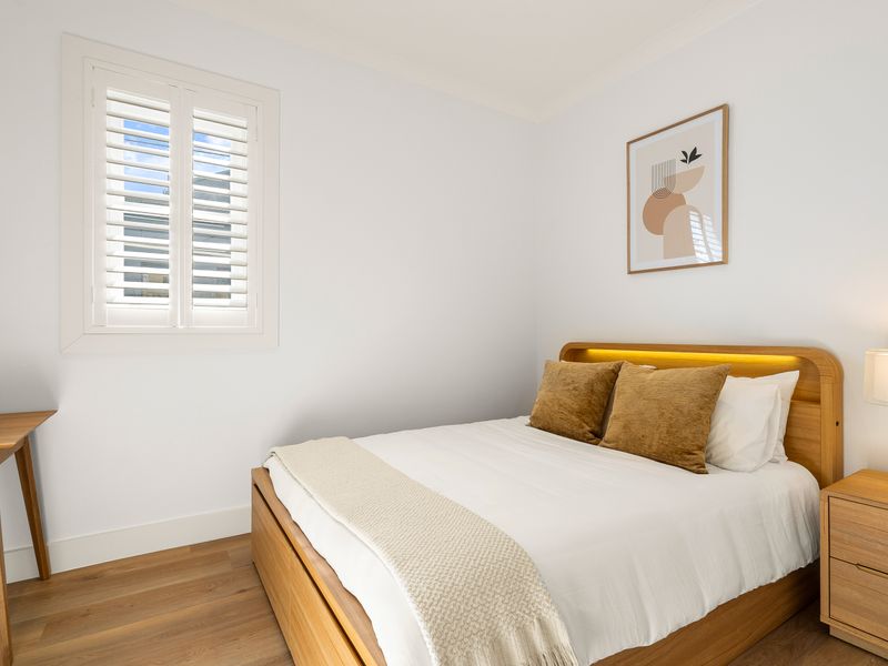 Wake up to natural light in this peaceful and inviting bedroom.