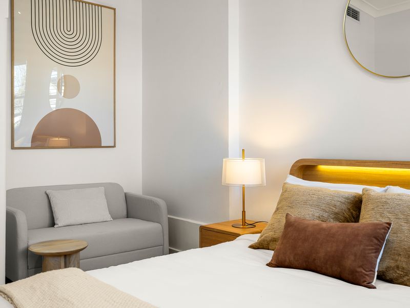 Comfortable reading nook beside the bedroom for quiet moments.